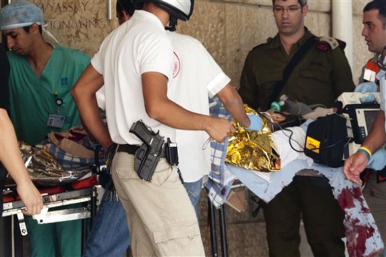 Israeli medics carry an injured police officer on a stretcher to a hospital in Jerusalem on Monday. 